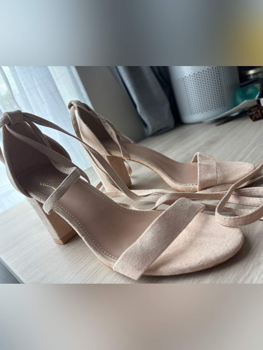 Suede nude pinky heels with wrap around straps.